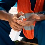 portrait-man-using-hand-sanitizer-close-up