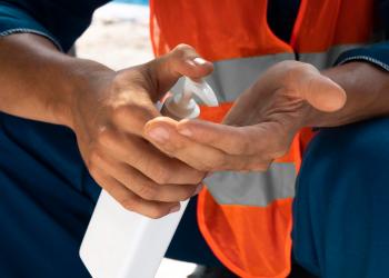 portrait-man-using-hand-sanitizer-close-up